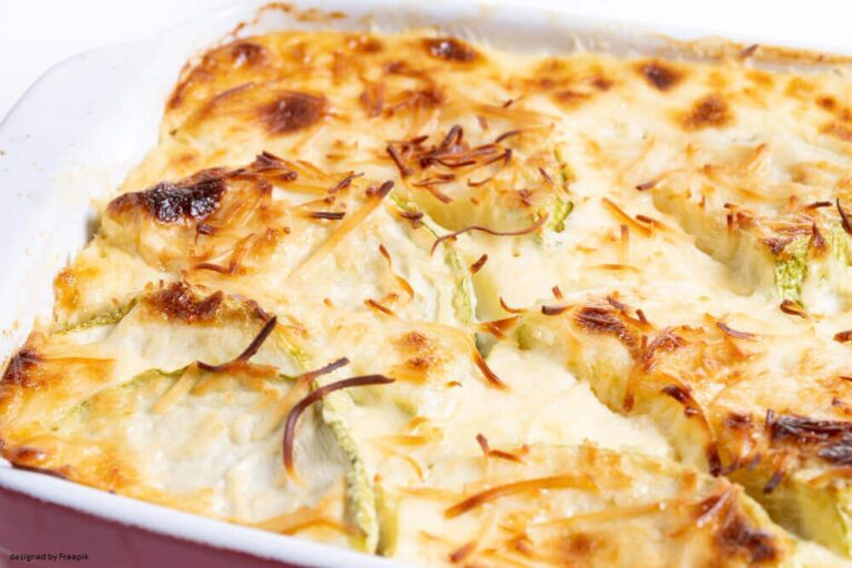 Golden-brown baked casserole with melted cheese and zucchini slices in a white dish.