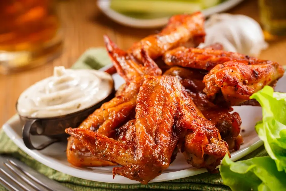 "Buffalo wings glazed with a sesame soy sauce, topped with sesame seeds and green onions, served with dipping sauces."